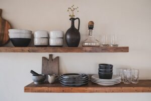 An open shelf with plates, bowls, glasses, etc.