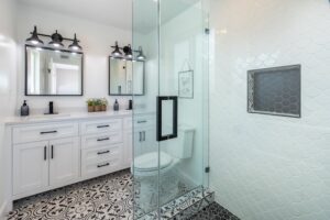 Shower and toilet seat in a Edmonds bathroom with white tiles.