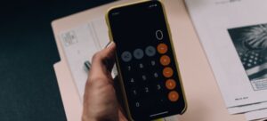A person holding a phone with the calculator app open
