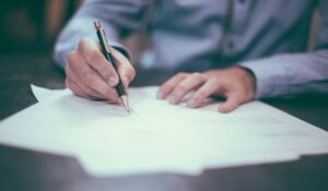 Man writing on a piece of paper