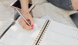 Woman taking notes in a diary.